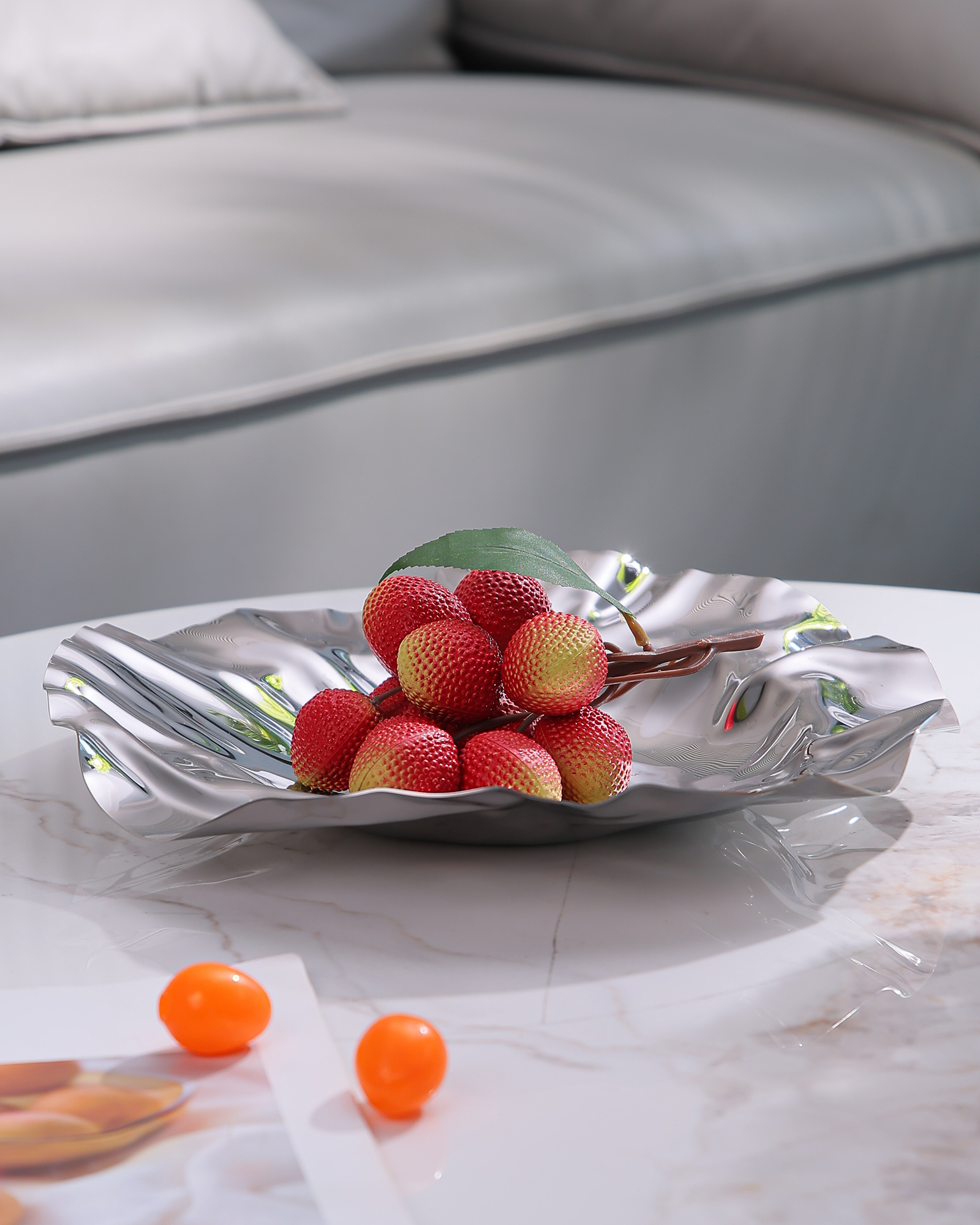 Polished stainless-steel fruit bowl in a refined interior